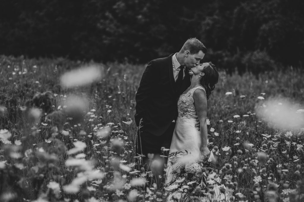 bride and groom wedding field wild flowers
